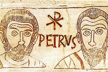 Die Gesichter von Petrus und Paulus als Gravur in einer römischen Katakombe. 