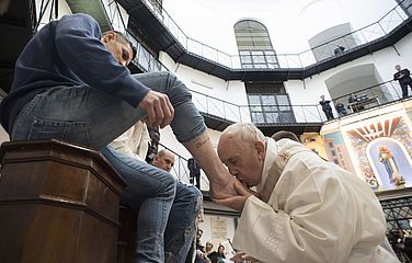 Papst Franziskus küsst den Fuß eines Häftlings.