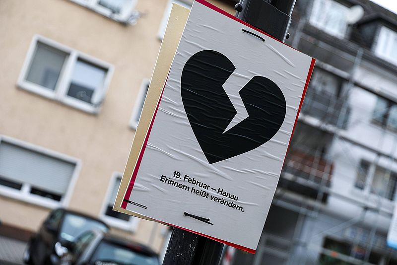 Ein Plakat zum Attentat in Hanau mit einem schwarzen, gebrochenen Herzen und der Aufschrift "19. Februar - Hanau - Erinnern heißt verändern.".