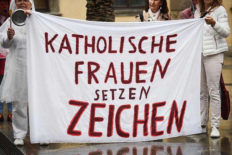 Frauen halten Banner mit der Aufschrift "Katholische Frauen setzen Zeichen"